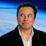 elon musk in front of image of earth from space