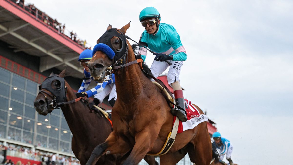 Jockey John Velazquez #1 riding National Treasure (FRONT) rides alongside jockey Irad Ortiz Jr. #7 riding Blazing Sevens to cross the finish line first to win the 148th Running of the Preakness Stakes