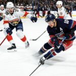 Artemi Panarin #10 of the New York Rangers skates with the puck against Josh Mahura #28 of the Florida Panthers at Madison Square Garden on March 23, 2024 in New York City.