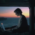 Asus promotional video for its new laptop showing a woman working on a computer overlooking the sea