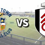 The Luton Town and Fulham club badges on top of a photo of Kenilworth Road stadium in Luton, England