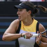 Jessica Pegula plays a shot in a yellow, white and black vest