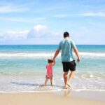 Father and Daughter playing on the beach