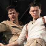 Mark Wahlberg stars as Victor “Sully” Sullivan and Tom Holland is Nathan Drake — both seen staring out of a helicopter —in Columbia Pictures