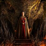 Queen Alicent (Olivia Cooke) stands in front of a huge dragon head in House of the Dragon Season 2 on Max