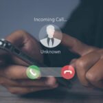 Phone scam showing an unknown caller on a phone screen