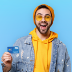 white hipster man in yellow hoodie holding a Tello SIM card