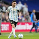 Lionel Messi on the ball for Argentina at the Copa America in the blue and white striped home kit