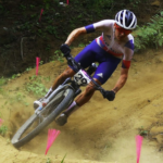 Thomas Pidcock of Team Great Britain bikes rides through a tight dusty corner in preparation for the mountain biking live streams at Olympics 2024