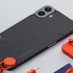 Nothing CMF Phone 1 in black with orange strap