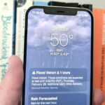 Weather app on an iPhone 12 running iOS 17 and showing a flood warning