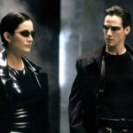 Trinity (Carrie Ann Moss) and Neo (Keanu Reeves) standing next to each other in