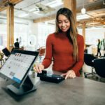 A woman swiping her card on a POS device