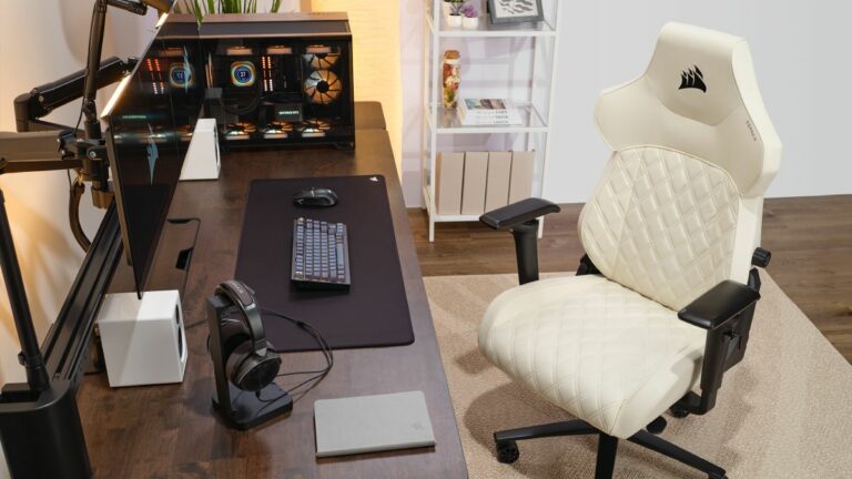 Corsair TC500 Luxe Gaming Chair in white in front of a desk with a gaming PC on it.