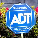 A Secured by ADT sign on a lawn