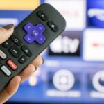 Roku remote in front of TV