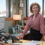 Hannah Hoeard (Felicity Ward) behind her desk in