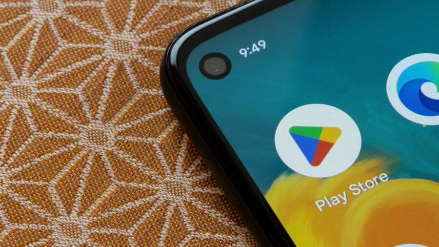 Google Play logo on an android smartphone with corner hole punch camera