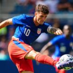 Christian Pulisic #10 of the United States strikes the ball ahead of the