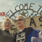 (From l to r) Harper Steele and Will Ferrell pose in front of a Welcome to Texas sign in Will &amp; Harper on Netflix