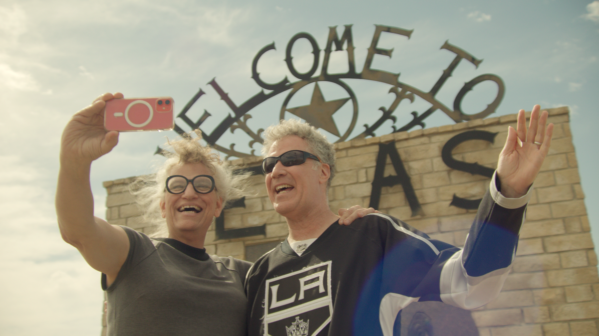 (From l to r) Harper Steele and Will Ferrell pose in front of a Welcome to Texas sign in Will &amp; Harper on Netflix