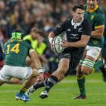 Will Jordan (C), in black, runs with the ball at the South Africa vs New Zealand live stream.