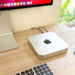 Apple Mac mini M2 on a desk, plugged in