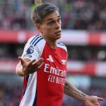 Leandro Trossard gesticulates on the pitch in his red and white Arsenal strip.