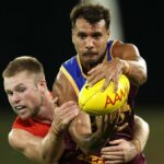 Callum Ah Chee of the Lions is tackled by Braeden Campbell of the Swans at the Sydney vs Brisbane live stream