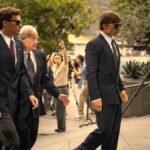 L-R: Erik (Cooper Koch), Peter Hoffman (Jeff Perry) and Lyle (Nicholas Chavez) arrive at court in &quot;Monsters: The Lyle and Erik Menendez Story&quot; on Netflix