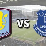 The Aston Villa and Everton club badges on top of a photo of Villa Park stadium in Birmingham, England