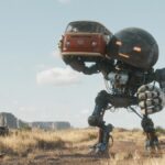 A screenshot from &quot;The Electric State&quot; showing robot Herman (voiced by Anthony Mackie) carrying a VW camper van