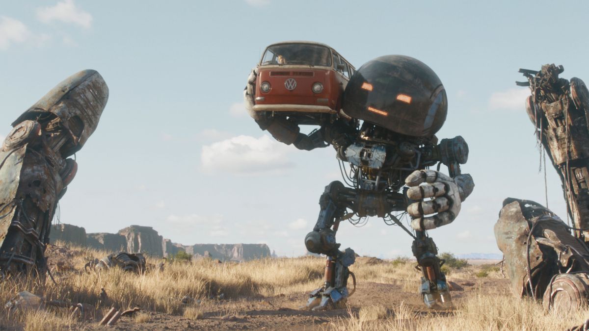 A screenshot from &quot;The Electric State&quot; showing robot Herman (voiced by Anthony Mackie) carrying a VW camper van