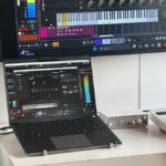 A musician shows off a Cubase digital audio workstation setup running natively on a Snapdragon X Elite-powered Copilot Plus laptop