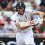 Zak Crawley of England plays a shot in his Test whites and blue England helmet.