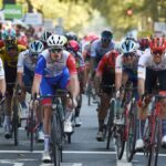 French rider of team Groupama FDJ Arnaud Demare (C) crosses the finish line ahead of the Paris-Tours 2024 cycling event.