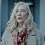 Actress Cate Blanchett, wearing warm winter clothing, looks shocks outside an expensive doorway in Apple TV+ original Disclaimer