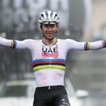 Tadej Pogacar of Slovenia and Team UAE Team Emirates celebrates as he crossing the finish line on his bike ahead of the