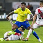 Gabriel (L), takes the ball out of danger, wearing the yellow and blue of Brazil, during Brazil vs Peru.