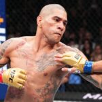 Tattooed, bald MMA fighter Alex Pereira of Brazil, wearing gold gloves, battles it out in the Octagon ring ahead of UFC 307: Pereira vs Rountree Jr.