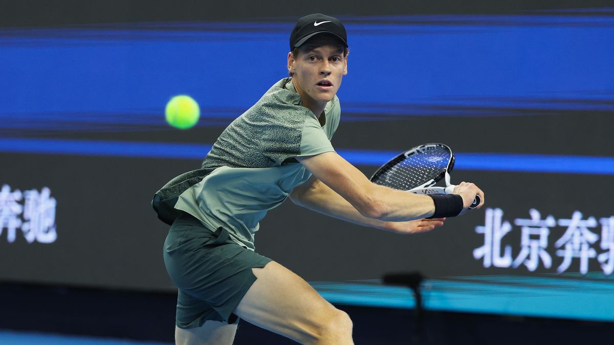 Jannik Sinner of Italy, wearing black nike cap and green shirt, returns a shot ahead of the 2024 Shanghai Masters tennis event