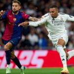 Kylian Mbappe of Real Madrid CF battles for the ball with Inigo Martinez of FC Barcelona during one of the biggest games of the La Liga 2024/25 season