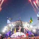 Night time view of Glastonbury Festival stage with crowd and fireworks