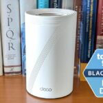 A TP-Link Deco BE63 mesh router with a Tom's Guide Black Friday Best Deals badge next to it