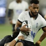 Fijian Waisea Nayacalevu is tackled with the rugby ball in his hands.