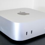 The Mac mini M4 on top of a desk riser shelf