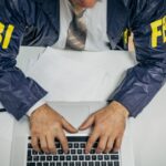 An FBI agent typing on a computer