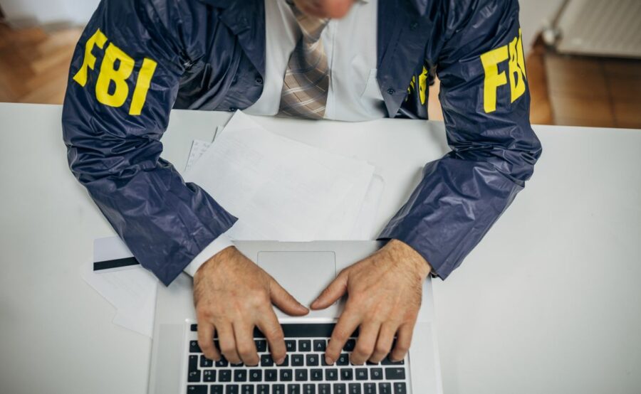 An FBI agent typing on a computer