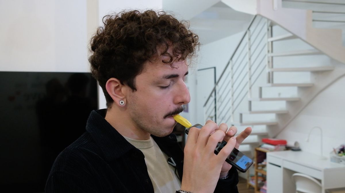 A man plays the Zefiro smartphone instrument attachment