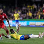 Ecuador's Pervis Estupiñán runs with the ball in a World Cup qualifier against Brazil in 2024.